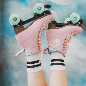 Lifestyle shot of the BTFL Ava Pro Roller skate with feet in blue sky