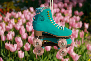 Lifestyle shot of the BTFL Liam Pro Roller skate hanging in front of tulips